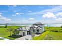 Stunning waterfront home with lush landscaping, modern design, and a beautiful lake view at 336 Caladium Ave, Lake Alfred, FL 33850