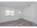 Bright living room featuring stylish flooring, white walls, and natural light from the window at 414 Tranquille Oaks Dr, Ocoee, FL 34761