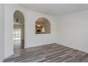 An open concept living room showing the stylish flooring and archway view to the kitchen at 414 Tranquille Oaks Dr, Ocoee, FL 34761