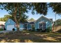 Charming single-Gathering home with a well-maintained lawn, white garage door and complementing light blue paint at 4523 Saddle Creek Pl, Orlando, FL 32829