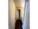 Hallway with wood flooring leading to the bathroom and other rooms at 516 Orange Dr # 17, Altamonte Springs, FL 32701