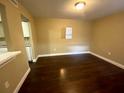 Open concept living room features beautiful dark wood flooring and neutral wall paint at 516 Orange Dr # 17, Altamonte Springs, FL 32701