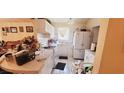 Bright kitchen with white appliances, tile floors and ample counter space at 5436 Bayberry Homes Rd, Orlando, FL 32811