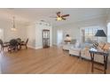 Bright living room featuring wood floors, neutral walls, and comfortable seating at 5795 Parkview Lake Dr, Orlando, FL 32821