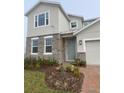 Charming home with a light-blue front door, stone accents, and neat landscaping at 5961 Vision Rd, St Cloud, FL 34771