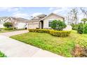 Inviting single-Gathering home with lush landscaping, stone accents and a brick driveway at 6097 Monterey Cypress Trl, Sanford, FL 32773