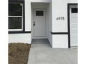 The front door of the house, highlighting its clean and simple design at 6915 Se 23 Ave, Ocala, FL 34480