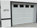 A close-up of the garage door, showcasing the design and the house number at 6915 Se 23 Ave, Ocala, FL 34480