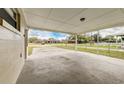 Spacious carport featuring a concrete floor and view of the surrounding neighborhood at 812 Oleander St, New Smyrna Beach, FL 32168