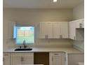 Bright kitchen featuring white cabinets, a modern sink, and a window view at 950 20Th St, Orlando, FL 32805