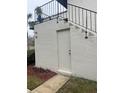 Exterior of condo building featuring stairs and side entrance at 96 Windtree Ln # 203, Winter Garden, FL 34787