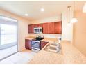 Well-lit kitchen boasts stainless steel appliances and granite countertops at 1132 Chelsea Dr, Davenport, FL 33897