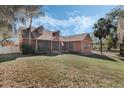 Beautiful single-Gathering home featuring lush landscaping and a screened front porch at 1031 Kings Hwy, Kissimmee, FL 34744