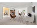 Spacious living room featuring a brick fireplace, neutral tones, and abundant natural light at 1232 Corbett Ln, Orlando, FL 32806