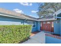 Inviting home entrance showcasing a double-door entry and well-maintained shrubbery at 1320 Corte Nueva, Winter Springs, FL 32708