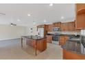 Well-equipped kitchen boasts an island, stainless steel appliances, and ample cabinet space at 1320 Corte Nueva, Winter Springs, FL 32708