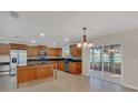 Bright kitchen with a center island, stainless appliances, and sliding door access to outdoor views at 1320 Corte Nueva, Winter Springs, FL 32708