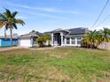 Inviting single-story home with a landscaped yard and an attached two-car garage at 1446 La Casita St, Deltona, FL 32725