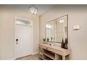 Inviting entryway featuring a console table, decorative mirror, and light fixture at 1656 Moon Valley Dr, Davenport, FL 33896