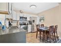 Well-lit kitchen featuring modern appliances, white cabinets, countertops and an adjacent dining space at 203 North E Blvd, Davenport, FL 33837
