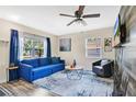 Inviting living room featuring a comfortable sofa, stylish decor, and ample natural light through the windows at 203 North E Blvd, Davenport, FL 33837