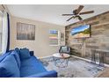 Inviting living room featuring a comfortable sofa, stylish decor, and ample natural light through the windows at 203 North E Blvd, Davenport, FL 33837
