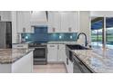 Stylish kitchen with a farmhouse sink, granite countertops, and stainless steel appliances at 2107 Stone Cross Cir, Orlando, FL 32828