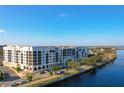 Scenic view of waterfront condo building with balconies overlooking the water and lush landscaping at 225 W Seminole Blvd # 314, Sanford, FL 32771