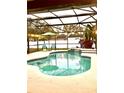 A relaxing screened-in pool features a waterfall and lush landscaping at 2655 Sheila Dr, Apopka, FL 32712