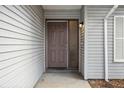 Inviting front entrance with a solid door, sleek hardware and complementary siding details at 353 E Orange St, Altamonte Springs, FL 32701