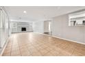 Bright living room featuring tile floors, a decorative brick fireplace, neutral paint, and ample natural light at 353 E Orange St, Altamonte Springs, FL 32701