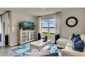 Bright living room featuring a large window with views of the outdoors and contemporary decor at 3751 Bluethread Way, Poinciana, FL 34759