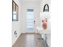 Bright entryway with neutral tile, console table, and modern decor at 4164 Paragraph Dr, Kissimmee, FL 34746