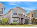 Modern two-story home featuring stone accents and a well-maintained lawn at 4164 Paragraph Dr, Kissimmee, FL 34746