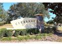 Stone Cimarron community sign accented by manicured shrubs, offering a glimpse of the neighborhood's charm at 4175 Sw 46Th Ct, Ocala, FL 34474