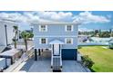 Two-story home with blue siding, white trim, and a charming front entrance with a private garage at 435 Jessamine Ave, New Smyrna Beach, FL 32169