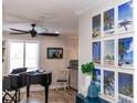 Living room features grand piano and beach-themed art at 435 Jessamine Ave, New Smyrna Beach, FL 32169