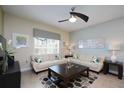 Cozy living room with neutral paint, a ceiling fan and comfortable seating area at 4879 Clock Tower Dr, Kissimmee, FL 34746