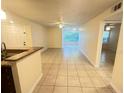 Spacious, brightly-lit living room featuring tile floors that lead to a cozy sun room at 5120 Conroy Rd # 513, Orlando, FL 32811