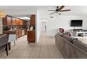 Open floor plan with living room with tile floors, neutral paint and kitchen with stainless steel appliances at 5201 Vineland Rd # 112, Orlando, FL 32811