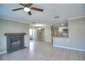 Open-concept living room with tile flooring, a fireplace, and a seamless transition to the kitchen area at 634 Steamboat Ct # 171, Altamonte Springs, FL 32714