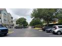 Wide view of the community street and condo buildings, showing the ample parking at 6412 Queens Borough Ave # 109, Orlando, FL 32835