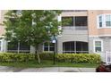 Close-up exterior view of condo building showcasing screened patios, landscaping, and accessible parking at 6412 Queens Borough Ave # 109, Orlando, FL 32835