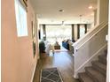 Bright, open-concept living room with hardwood floors and view to the outdoor space at 645 Astera Winds Ln, Lake Mary, FL 32746