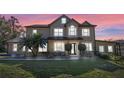 Beautiful two-story home featuring mature palm trees during sunset at 740 Hillcrest Ln, Altamonte Springs, FL 32701