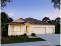 Charming single-story home with neutral stucco, a three-car garage and well manicured lawn at 914 Boyte St, Port Orange, FL 32127