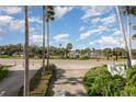 Beautifully landscaped street view of a tropical oasis with palm trees and clear blue skies at 1 John Anderson Dr # 317, Ormond Beach, FL 32176