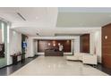 The elegant lobby features sleek tile floors, modern lighting, and minimalist decor, creating a welcoming atmosphere at 101 S Eola Dr # 1119, Orlando, FL 32801