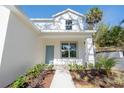 Inviting front entrance featuring a light blue door, lush landscaping, and a welcoming walkway at 1045 Morningside Dr, Eustis, FL 32726