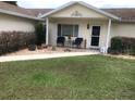 Charming home exterior featuring a cozy front porch with seating and manicured landscaping at 10839 Sw 78Th Ct, Ocala, FL 34476
